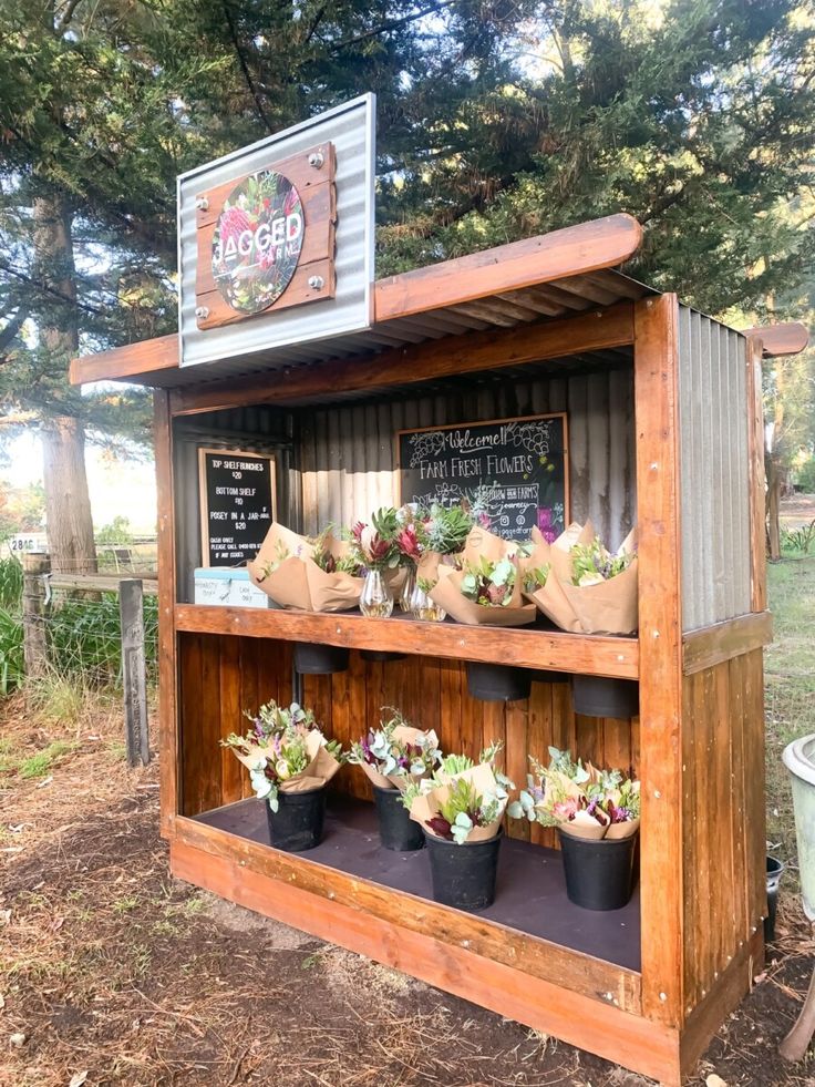 a wooden stand with plants on top of it