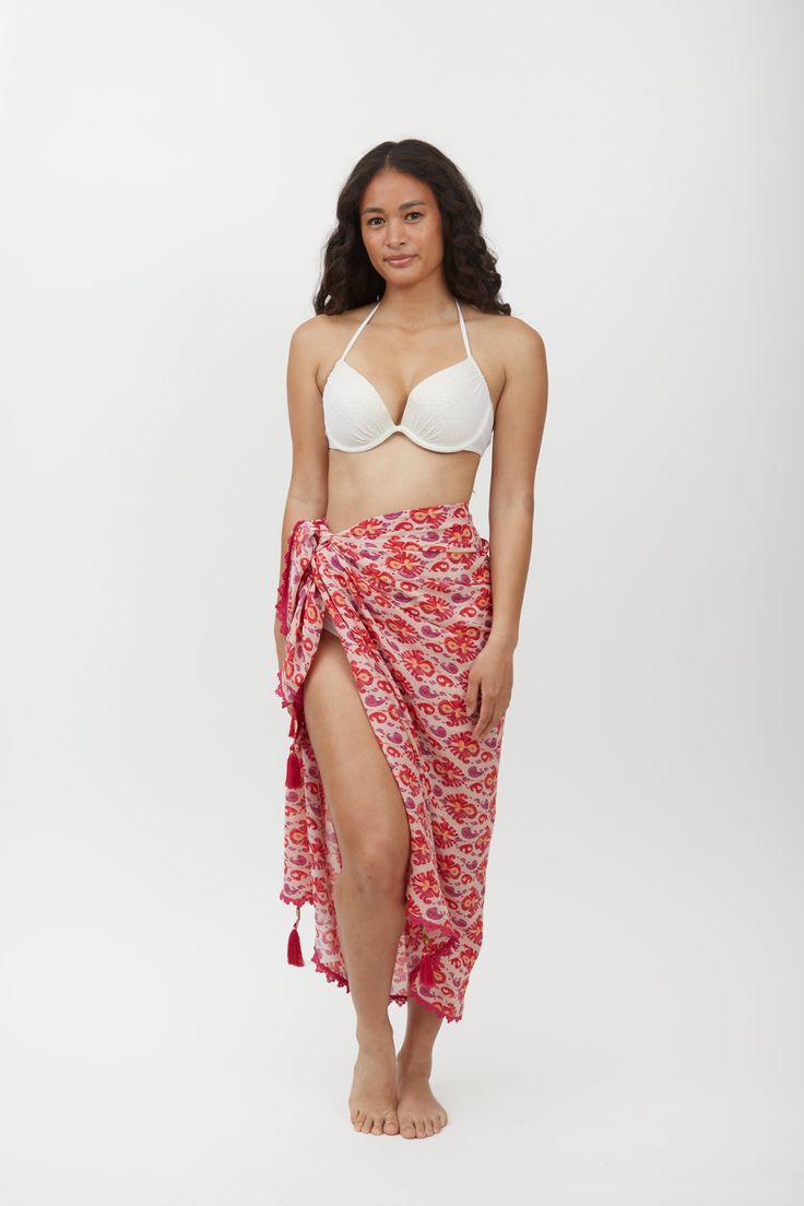 Crafted from lightweight cotton fabric, this sarong can be styled in multiple ways – wear it as a beach cover-up, a scarf, or a wrap skirt. The vibrant Aztec motif print adds a pop of color and pattern to your beach ensemble, making it a standout piece in your vacation wardrobe. Whether lounging by the pool or strolling along the shoreline, the Margot Sarong is the perfect companion for your next tropical getaway. Beachy Wrap Sarong For Beach Cover-up, Tropical Tie-side Sarong For Beach Cover-up, Bohemian Tropical Print Sarong For Pool, Bohemian Sarong With Tropical Print For Pool, Beachy Cotton Sarong For Vacation, Summer Tie-side Sarong For Beach Cover-up, Summer Beach Sarong With Block Print, White Wrap Sarong For Beach, Bohemian Tie-side Sarong For Vacation