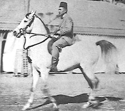 a man riding on the back of a white horse