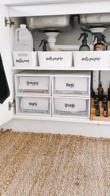 an organized bathroom cabinet with labels on the drawers