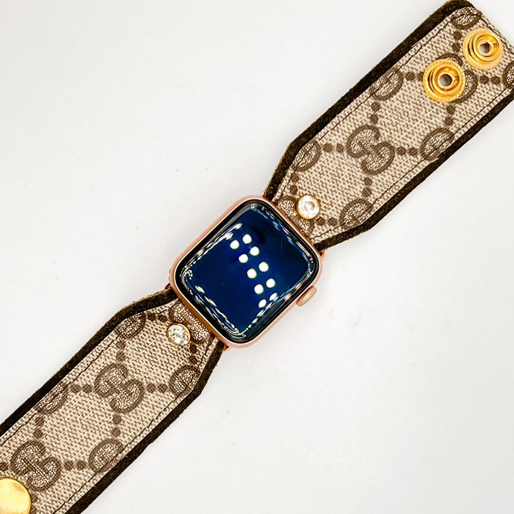 The "Willow" is a beauty and is a hand-crafted designer watchband made with olive green suede leather and topped with the classic brown GG monogram material from a real bag. The band is secured with gold fitting connectors that will slide into your apple watch securely. There are two gold high-quality snaps have been added to allow for adjustability and comfort fit. Each band is approximately 3.5 inches with snaps at .5 and 1.25. The secure clear crystal adds a nice little bling to the band! Fit Designer Gold Leather Watch Accessories, Luxury Gold Watch Accessories With Leather Strap, Luxury Gold Watch With Leather Strap, Designer Gold Watches With Leather Strap, Designer Brown Adjustable Bracelet, Designer Adjustable Brown Bracelet, Luxury Gold Leather Strap Watch Bands, Luxury Brown Adjustable Bracelet, Luxury Brown Adjustable Watch