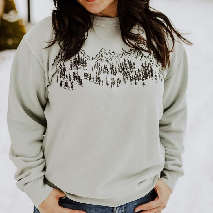 Mountain Sketch Unisex Pullover - SageThis item continues to be a top seller and is always flying off the shelves. Grab one for all your adventures. Model is wearing a size medium.80/20 cotton/polyester Body Length 27 28 29 30 Chest Width (Laid Flat) 20 22 23 1/2 25 1/2 Sleeve Length (From Center Back) 34 1/2 35 1/2 36 1/2 37 1/2 Mountain Sketch Unisex Pullover - Sage A Montana Scene Original Design. Printed in Montana. All designs are property of The Montana Scene. All rights reserved. Come vis Mountain Sketch, One For All, Autumn Night, Sage Color, Top Seller, Staple Pieces, Original Design, Original Designs, Crew Neck Sweatshirt