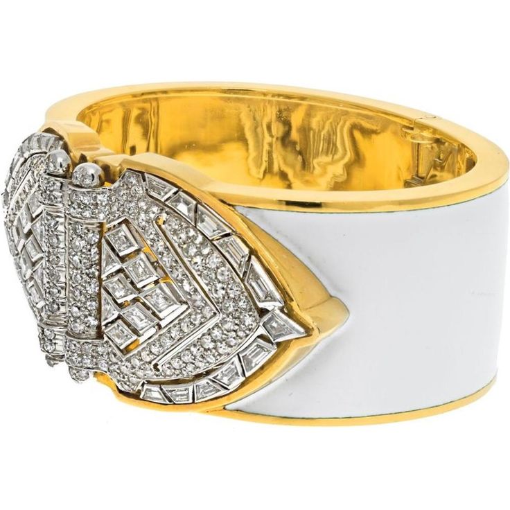 Bask in the brilliance of fine craftsmanship and innovative design with the David Webb Platinum & 18K Yellow Gold White Enamel Shield Diamond Clips Cuff Bracelet. This exquisite piece of jewelry exudes old Hollywood glamour, featuring platinum diamond shield-shaped ends that can be detached and worn as double clips. Adorned with a dazzling array of step-cut and brilliant-cut diamonds, this bracelet is a testament to elegance and sophistication.The design, crafted with white enamel, imbues the piece with a timeless quality, ensuring it remains a cherished heirloom for generations. Measuring around 6 inches in circumference, this bracelet is designed for a small wrist size, making it a perfect fit for those who appreciate bold yet refined accessories. The width of approximately 1.2 inches en Luxury Cuff Bracelet With 17 Jewels For Anniversary, Luxury White Pavé Setting Bracelet, Luxury White Bracelet With Pave Setting, Fine Jewelry White Bangle With Single Cut Diamonds, White Bangle With Single Cut Diamonds, Luxury Diamond Cuff Bracelet With Diamond Accents, Luxury White Gold Cuff Bracelet, Luxury White Diamond Bracelet With Single Cut Diamonds, Luxury Evening Cuff Bangle