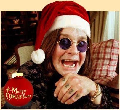 a woman wearing sunglasses and a santa hat is smiling at the camera with an ornament in front of her