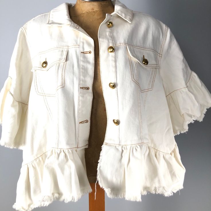 The Cutest Jean Jacket You Ever Did See! The Tov Ruffle Denim Jacket From Nordstrom Rack. Loving The Short Ruffle Sleeves And Ruffle Hemline, So Trendy And Fab! This Has Two Functional Breast Pockets, Copper Hardware And Comes In Cream. The Frayed Edges Might Be My Favorite Part About This! Take On The Spring Season With This Cutie, You Won’t Regret It! Relaxed Fit Ruffled Short Sleeves Two Functional Breast Pockets Distressed Ruffled Hem Four Button Front Closures Not Lined Cotton Denim Jacket With Frayed Hem For Day Out, Chic Cotton Outerwear With Frayed Hem, Cotton Outerwear With Frayed Hem For Day Out, Chic Summer Denim Jacket With Frayed Hem, Chic Collared Cotton Denim Jacket, Chic Spring Denim Jacket With Frayed Hem, Casual Summer Outerwear With Ruffles, Casual Ruffled Summer Outerwear, Fall Cotton Outerwear With Ruffles