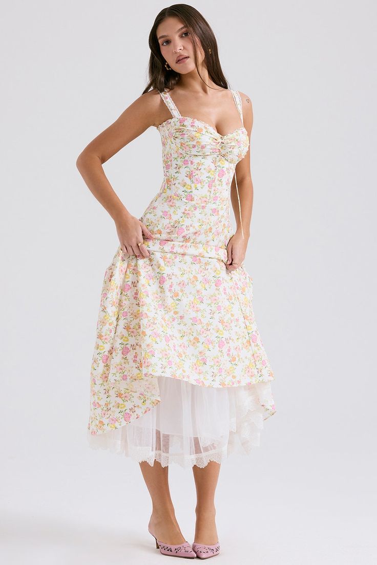 This dress is cut from stretch cotton that's bursting with elegant florals. It has a gathered bust with a corseted bodice and the skirt falls beautifully from the cinched waist. There's a pretty lace trim that peeks below the hemline. The soft tulle underskirt enhances the ultra feminine silhouette making it the perfect Garden Party dress for warmer days. Midi Sundress, Cotton Sundress, Suspender Dress, Sweet Floral, Bustiers, Tea Dress, Flare Skirt, Dress Long, Long Skirt