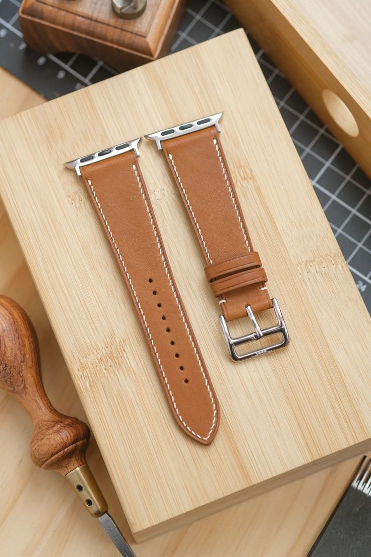 Entirely handmade gold barenia watch strap. The leather epsom comes from the French tannery Haas, and is used by many luxury brands for their leather watch straps. Epsom has a defined grain and is highly resistant to scratches. It is also water resistant and commonly used in bag and wallets. Unlike many other examples listed on Etsy, this strap is entirely hand-stitched. Please note that this strap is ONLY available for the Apple Watch. If you are looking at this strap for another watch, we are Classic Leather Strap Apple Watch Band For Business, Classic Business Apple Watch Band With Leather Strap, Classic Business Apple Watch Bracelet Strap Band, Classic Business Apple Watch Band With Bracelet Strap, Classic Business Apple Watch Bracelet Strap, Classic Adjustable Apple Watch Band For Business, Classic Adjustable Apple Watch Band, Classic Leather Strap Apple Watch Band For Formal Occasions, Timeless Rectangular Bracelet Strap Watch Band