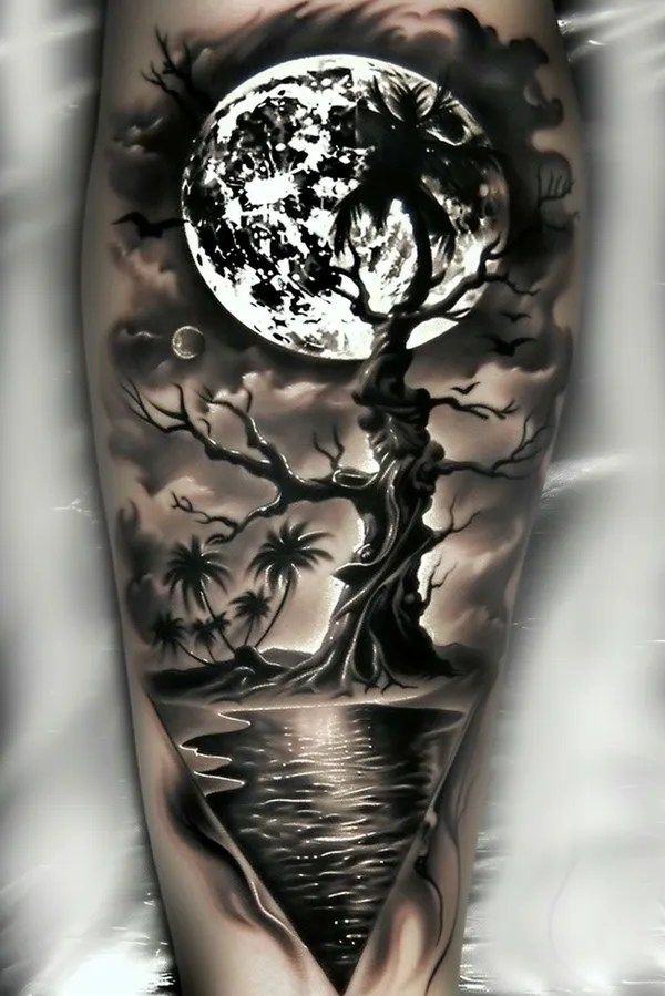 a man's leg with a full moon and tree on the water in front of it