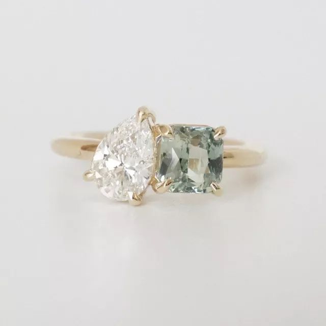 two stone engagement ring in yellow gold with an aqua and white topazte center