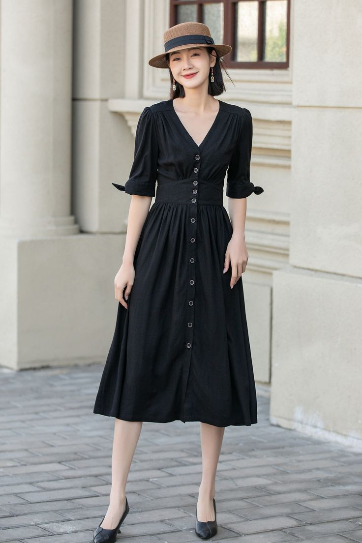 "Stay cool and stylish this summer with our black linen short-sleeved dress. Featuring a flattering deep V-neckline and waist-cinching button details, this dress is perfect for any body type. Made with high-quality linen, it's breathable and comfortable even on the hottest days.This lightweight and breathable dress is perfect for any occasion, from a day out with friends to a beach vacation. DETAILS 100% Linen dress No pockets Deep V neck Single breasted  Button down dress Linen shirt dress Spring, summer Dry clean *The model is 170 cm (5′7″) tall with a 80 cm (31.5\") bust, 66 cm (26\") waist. She is wearing the black dress in size XS. * Choose CUSTOM Order if you Can't find your size in our size Chart Chang the Length Your Height is not Between 5'1\" - 5\"8\" Your weight over 47kg-75kg S Black Short Sleeve Midi Dress For Summer, Casual Black Short Sleeve Dress For Summer, Black Linen Short Sleeve Dress For Spring, Black Short Sleeve Linen Dress For Spring, Black Linen Dress For Summer, Elegant Black Short Sleeve Dress For Summer, Elegant Black Short Sleeve Summer Dress, Elegant Short Sleeve Mid-length Dress For Summer, Black Linen Dress For Spring Beach Outing