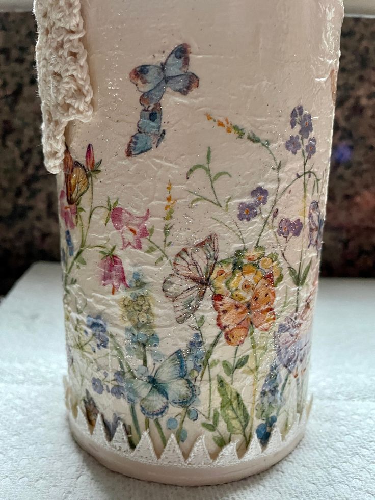 the vase is decorated with flowers and butterflies