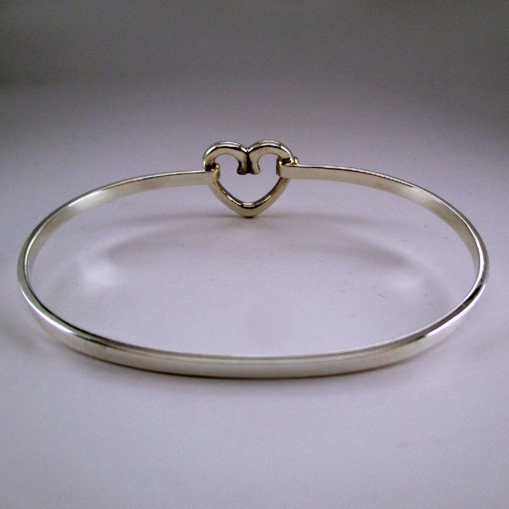 "This sterling silver Open Heart Bangle bracelet features a graceful heart design. The bangle accommodates medium and large spacer beads, European charm-beads, and traditional charms. Made by Brown County Silver. Marked Sterling. Available in small, medium, and large Small - 6.5\" Medium - 7.25\" Large - 8\" Approximate weight is 9.1 grams *Charm not included See more @ https://www.etsy.com/shop/brocosi" Silver Heart Charm Bangle Bracelet, Adjustable Sterling Silver Heart Bangle Bracelet, Sterling Silver Heart Bangle For Wedding, Adjustable Sterling Silver Open Heart Bracelet, Silver Open Heart Bracelet For Wedding, Sterling Silver Heart Bangle For Valentine's Day, Sterling Silver Open Heart Wedding Bracelets, Valentine's Day Sterling Silver Heart Bangle, Sterling Silver Heart Bangle For Anniversary