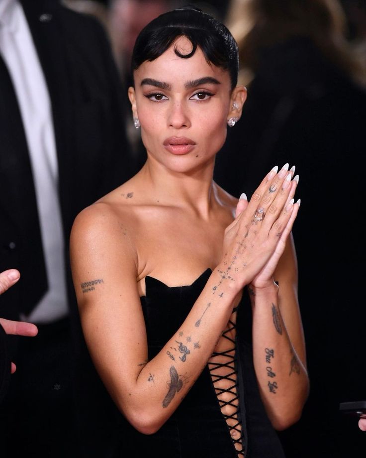 a woman with tattoos on her arms and hands