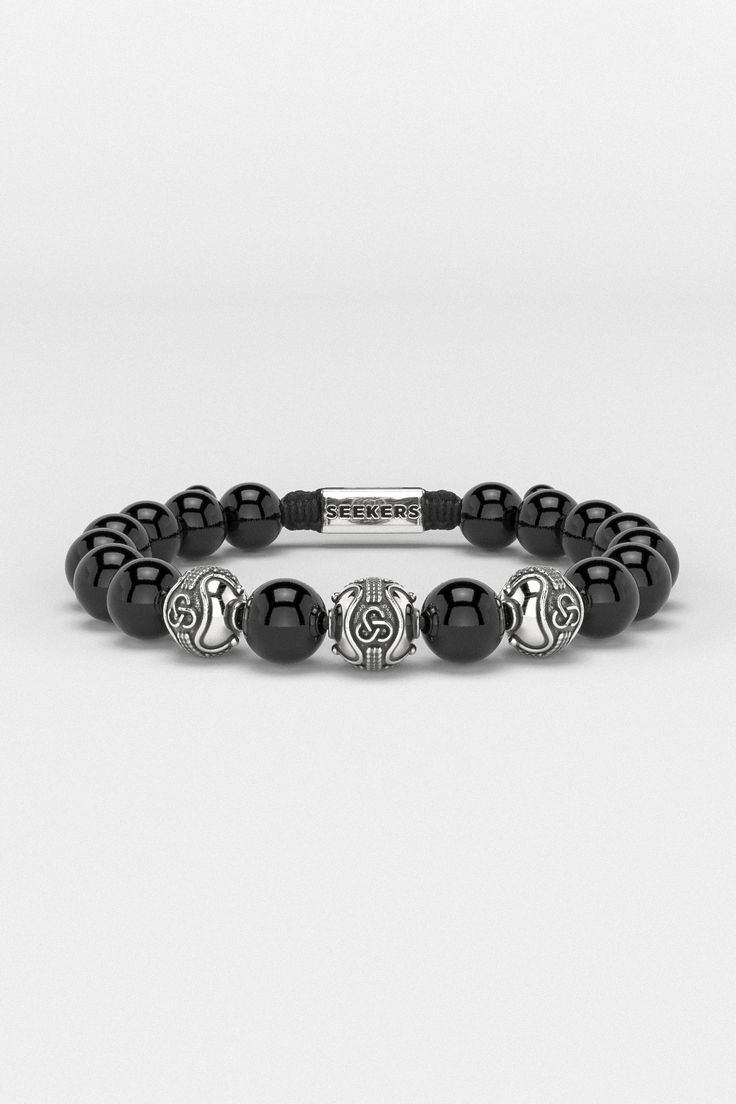 Introducing the Premium Bracelet, embodying the eternal quest for personal growth and self-realization. Its design, inspired by an infinite symbol in three dimensions, represents the mind, body, and spirit's interconnected journey. This piece symbolizes the relentless pursuit of one's true purpose, reminding us that in every mindful step lies the essence of life and the path to becoming the person we aspire to be. All our stones are chosen by hand to satisfy AAA quality standards. They are natural stones and their size and color can vary slightly. Stone: AAA Grade 10mm (Choose your favorite from available ones) Metal: 925 Sterling Silver / 24k Gold Plated / Rhodium over 925 Sterling Silver 100% Handcrafted Package: High quality velvet pouches Modern Black Bracelet With 8mm Beads, Modern Black Bracelets With 8mm Beads, Modern Gemstone Beads Bracelets, Luxury Black Jewelry With 8mm Beads, Modern Adjustable Onyx Bracelet, Modern Onyx Bracelets For Gift, Luxury Sterling Silver Round Bead Bracelets, Modern Onyx Bracelets For Gifts, Modern Onyx Bracelets As Gift