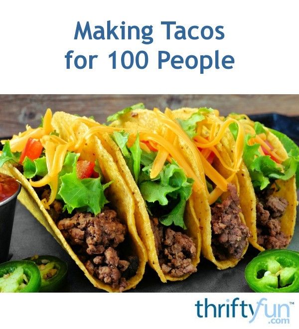 three tacos with shredded cheese, lettuce and tomato on top are sitting on a plate