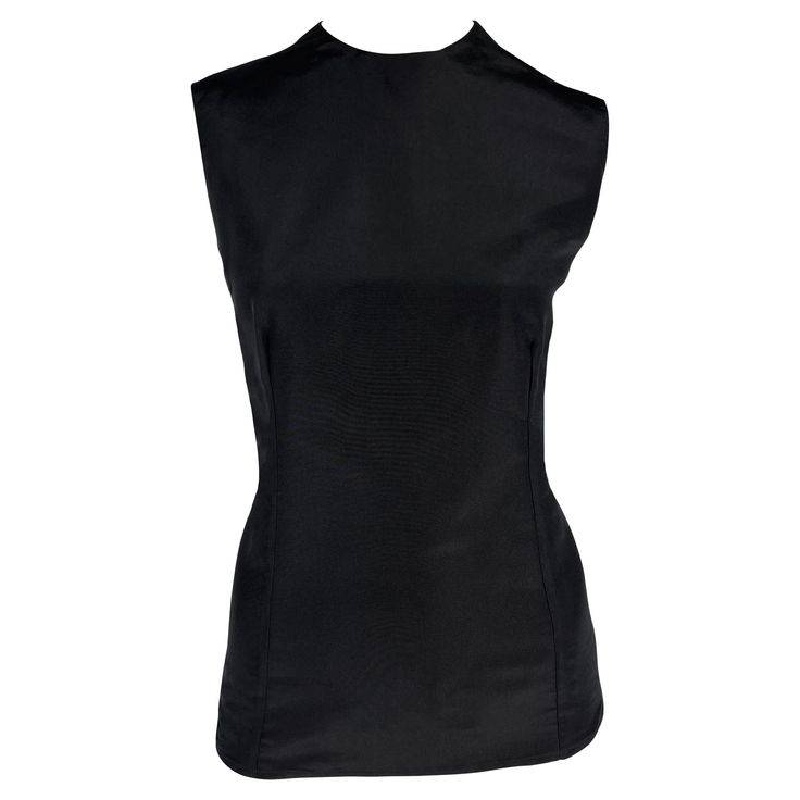 From the Spring/Summer 1990 collection, this Gianni Versace black silk sleeveless top is the perfect elevated essential. Approximate measurements: Size - 42IT Shoulder to hem: 24" Bust: 36" Waist: 32" 100% Silk Silk Fitted Tank Top For Evening, Fitted Sleeveless Formal Top, Fitted Sleeveless Top For Formal Occasions, Black Silk Sleeveless Tank Top, Fitted Silk Tank Top For Work, Formal Silk Tank Top For Summer, Chic Sleeveless Silk Vest, Silk Sleeveless Tank Top For Work, Black Fitted Tank Top For Evening