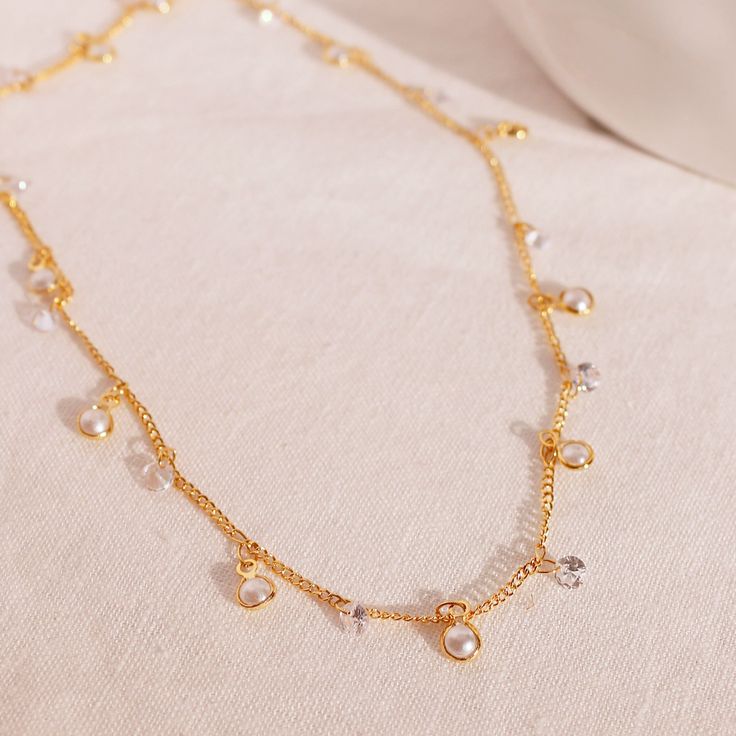 "Elevate your elegance with our Pearl Cubic Necklace, a truly fancy and shiny accessory that's perfect for any party. Let your style shine with this exquisite piece of jewelry. Personalized Y Necklace https://www.etsy.com/listing/1523378005/personalized-y-necklace-16k-gold-plated double chain simple initial necklaces https://www.etsy.com/listing/1521967169/double-chain-simple-initial-necklaces # SPECIFICATION Material: 16K Plated Jewelry Color: Gold ball size: 3.3mm ball Chain length: 17.5\" Ple Fine Jewelry Bridal Necklace With Jewels For Party, Gold Dainty Crystal Necklace With Cubic Zirconia, Gold Dainty Cubic Zirconia Crystal Necklace, Dainty Gold Crystal Necklace With Cubic Zirconia, Silver Gold-plated Chain Necklace For Party, Silver Gold-plated Necklace For Party, Elegant Gold Crystal Necklace As Gift For Her, Dazzling Diamond Necklace With Clavicle Chain For Party, Silver Gold Plated Chain Necklace For Party