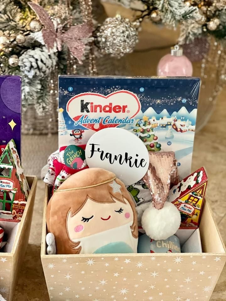 two boxes filled with candy and candies on top of a table next to a christmas tree