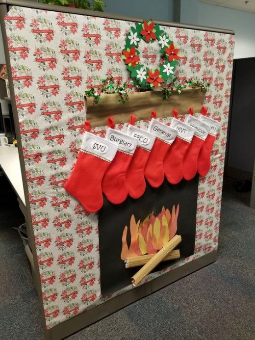 christmas stockings hanging over a fire in an office cubicle decorated for the holiday season