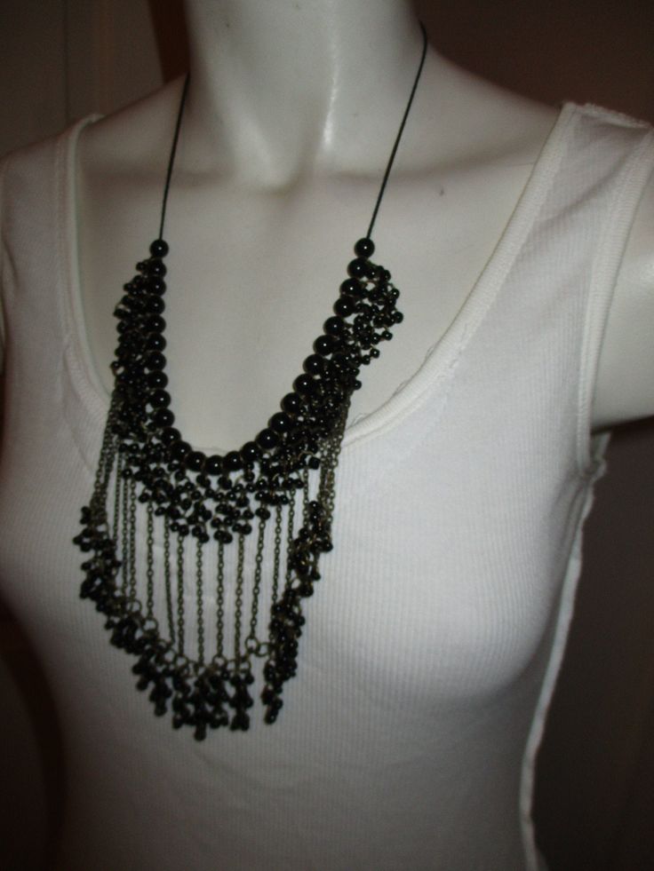 "From around the 1980's or 90's. Black beads with antique gold chains strung on a black cord. It has 2 lobster claw clasps hooked together. It's 23\" long. The fringe has a 4\" drop. I ship same or next business day." Adjustable Beaded Tassel Necklace For Party, Adjustable Bib Necklaces With Dangling Beads For Parties, Adjustable Bib Necklace With Dangling Beads For Party, Metal Beaded Necklace With Dangling Beads For Party, Party Bib Necklaces With Dangling Beads, Multi-strand Beaded Necklaces For Party, Beaded Dangle Chain Necklace For Party, Multi-strand Party Beaded Necklace With Dangling Beads, Party Multi-strand Beaded Necklace With Dangling Beads