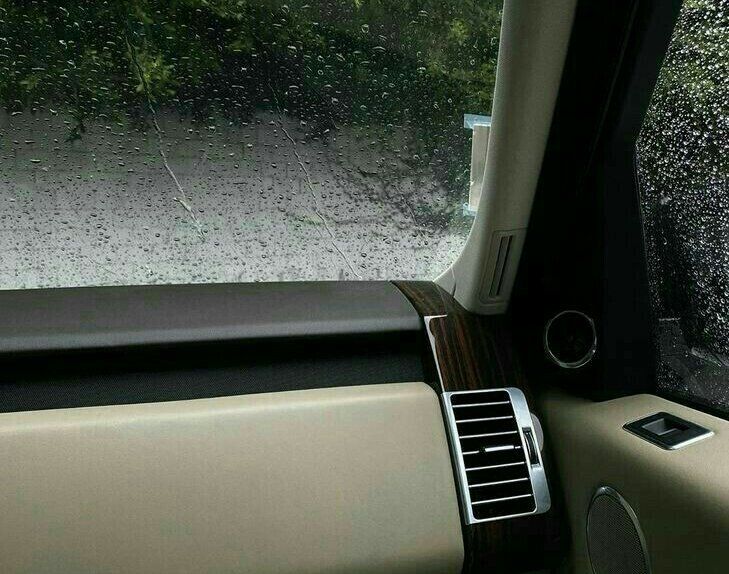 the inside of a car with rain on the windshield