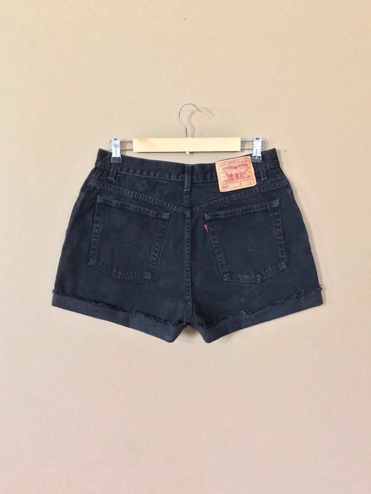 "High waisted 90's denim shorts. Made by Levi's in classic black denim wash. Shorts are in excellent clean condition. Perfectly worn in with light naturally distressed character. These have been cut off and washed once. Measurements are taken zipped or buttoned up and laid comfortably flat then x 2 for total circumference (inches) Tag Size 14 Reg Levis 550 100% Cotton ~Measure Rise First~ Waist 31\" Hips 44\" Length 15\" Inseam 4\" Rise 12\" leg opening circumference 25\" All items are free of r Grunge Jean Shorts With Built-in Shorts, Grunge High Waist Jean Shorts With Built-in Shorts, 90s Style Cutoff Bottoms For Streetwear, Fitted Cutoff Shorts For Streetwear, Retro Cutoff Jean Shorts For Streetwear, Vintage Black Shorts For Summer, Black 90s Style Jeans For Summer, Grunge Bottoms With Belt Loops For Summer, Cutoff Shorts With Belt Loops For Streetwear