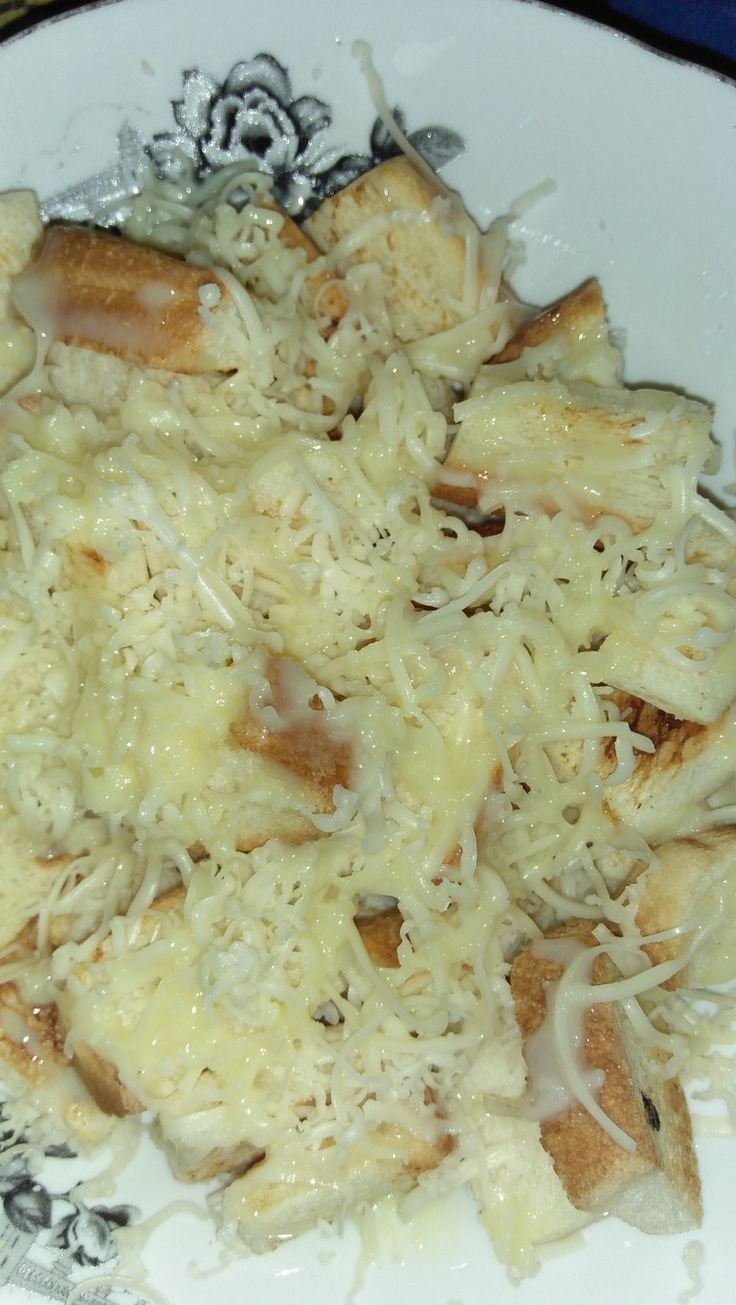 a white plate topped with cheese and bread