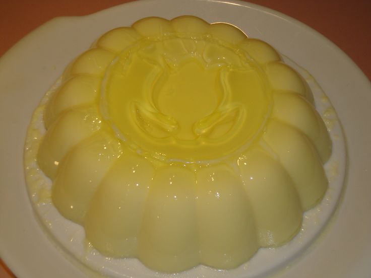 a white plate topped with a cake covered in yellow icing