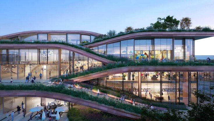 people are walking around in front of some glass buildings with plants growing on the roof