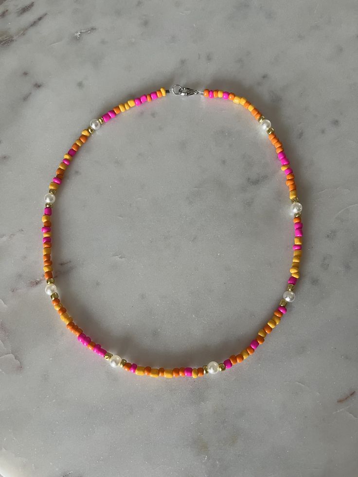 a beaded necklace on a marble surface