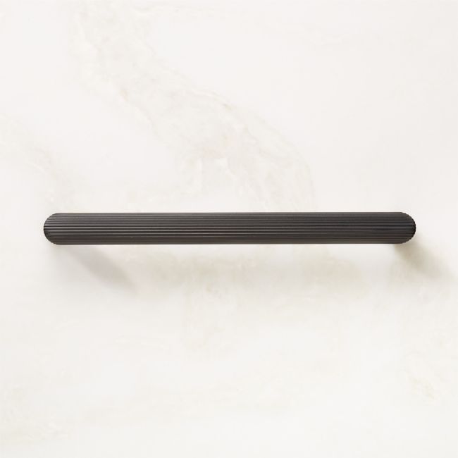 a black handle on a white wall