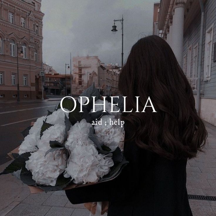 a woman walking down the street with flowers in her hand and an ophelia ad above her