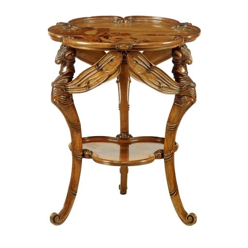 an ornate wooden table with glass top