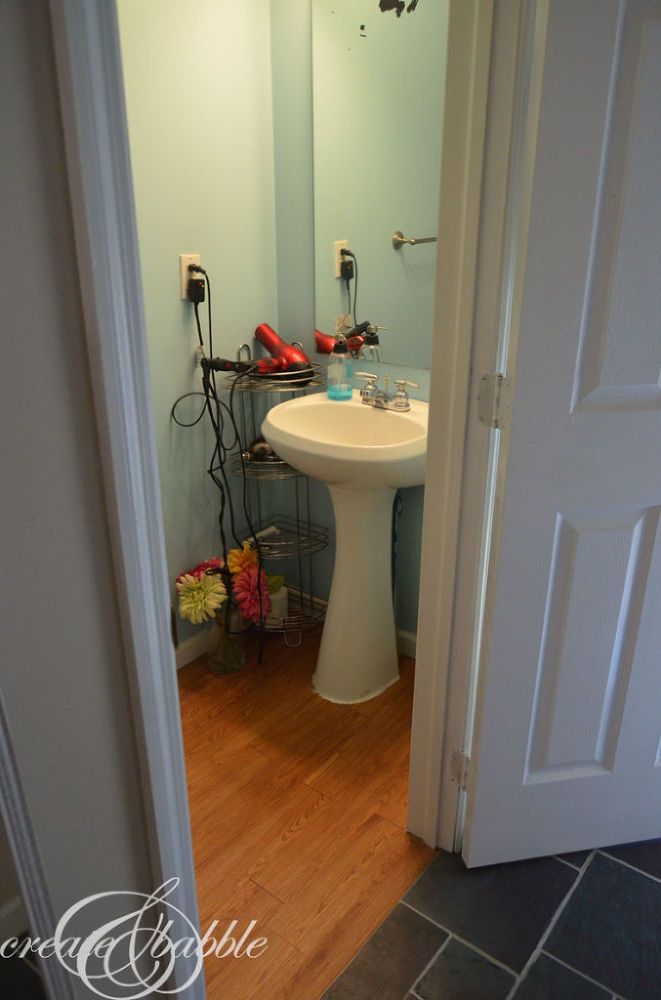 a bathroom with a sink, mirror and hair dryer