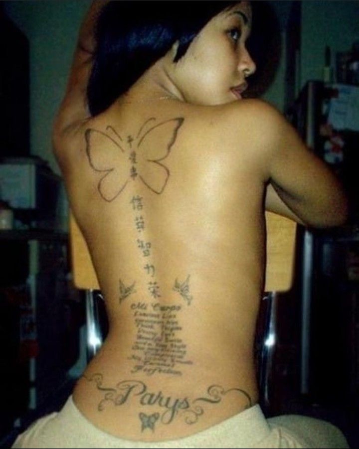 a woman with a butterfly tattoo on her back