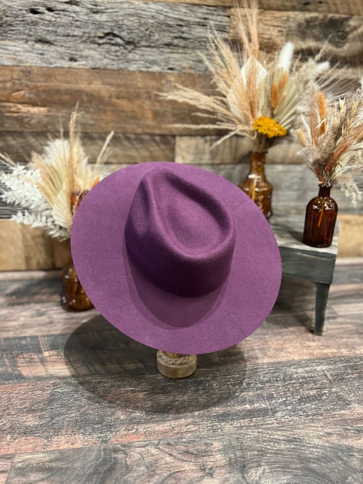 Plum Felt Hat Its classic design makes it the ideal accessory for any occasion, allowing you to easily dress it up or down to suit your style. Experience the perfect blend of sophistication and versatility with our Rancher Felt Fedora Hat, your go-to choice for enhancing your wardrobe. Featuring a sewn-in sweatband with a unique hidden pull strap tightening system for a one of a kind fit! Plus we’ll include two adhesive size reducers for an even more custom experience. Brim Measures 3 1/2" Crown Chic Fitted Brimmed Fedora, Chic Fitted Fedora With Brim, Chic Wide Brim Fitted Fedora, Elegant Fedora With Flat Brim, One Size Fits Most, Elegant Flat Brim Fedora One Size Fits Most, Trendy Fitted Fedora With Curved Brim, Elegant Wide Brim Panama Hat For Fall, Elegant Flat Brim Hats For Fall, Fitted Purple Hat With Short Brim