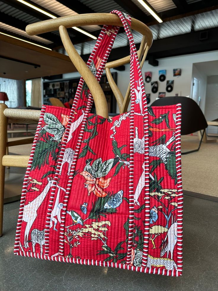 a red bag sitting on top of a wooden chair