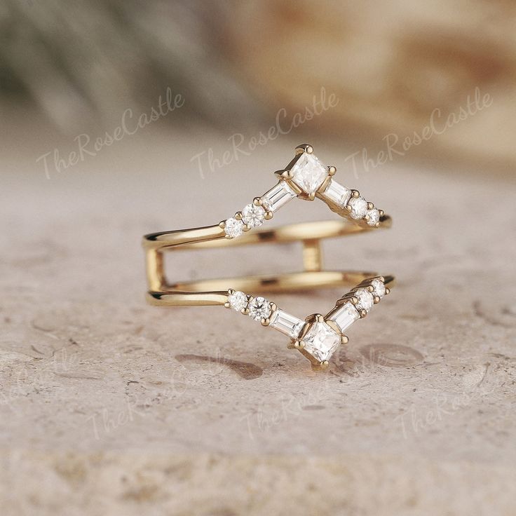 two gold rings sitting on top of each other with white stones in them and the middle one has three smaller diamonds