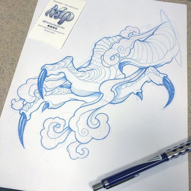 a drawing of a dragon on paper with a pen