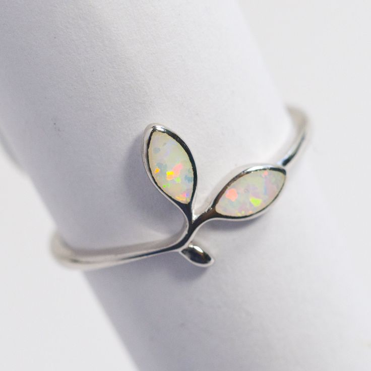 All Sterling Silver items in our shop are stamped 925, lead and nickel free, solid 925 silver, NOT plated or filled. Opal Floral design 925 Sterling Silver Band Lab grown Fire White Opal Band Dainty Stackable Minimalist Simple Thumb ring October Birthstone Simple Silver Band great for every day made with finest quality sterling silver 925.  Opal is the October Birthstone. Wearing Opal is considered by many to brings loyalty, faithfulness and spontaneity in the wearer.  Low profile, very smooth, Nickel-free Open Band White Gold Jewelry, Adjustable White Gold Opal Birthstone Ring, Nickel Free White Gold Open Band Jewelry, Nickel-free White Gold Open Band Jewelry, White Sterling Silver Dainty Midi Rings, Dainty White Sterling Silver Midi Rings, Adjustable Silver Opal Promise Ring, Adjustable White Gold Opal Ring, Adjustable White Gold Opal Ring In Fine Jewelry Style