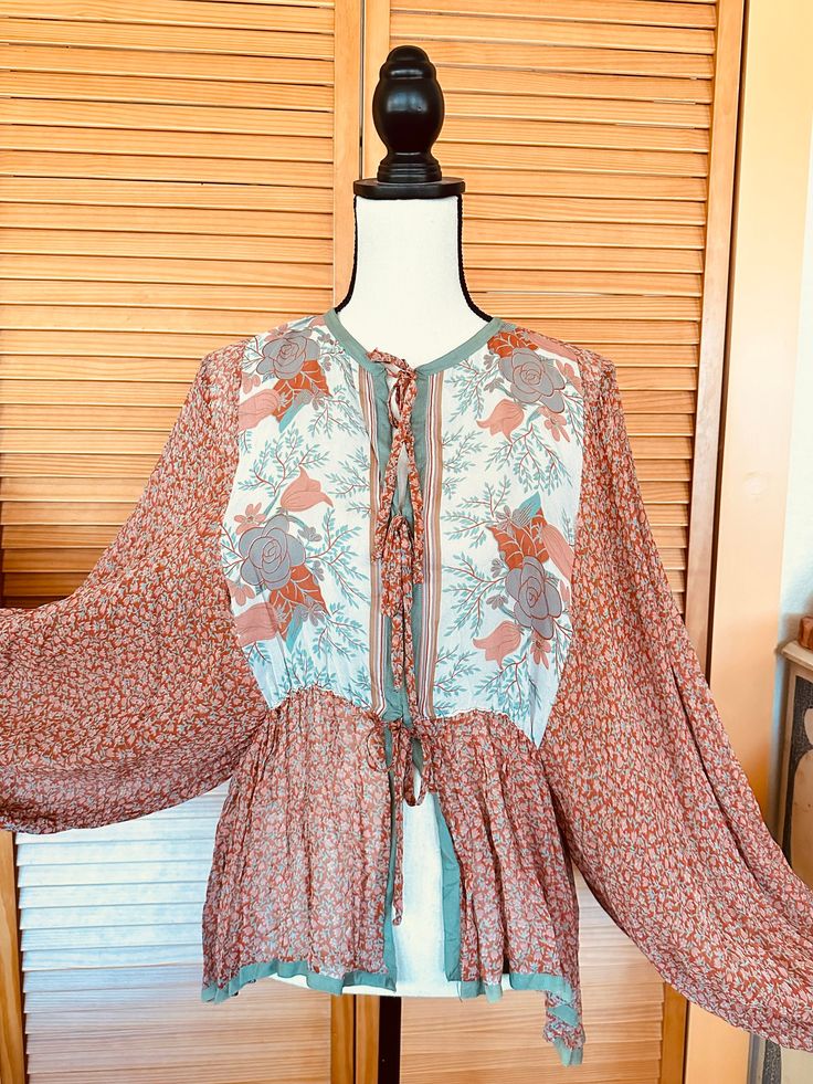 ... Absolutely gorgeous  I purchased this at the Rose Bowl Fkea Market years ago. Strip Thrills label Hollywood  Beautiful sheer silk  1970's blouse  Puffy Dolman sleeves Contrasting floral yoke Abstract floral print sheer crepe fabric Satin trim Measures : Large flowy sleeves that start at the waist-  Chest up to 34" Waist 36" Collar to hem 29" Great condition  One faded section on the sleeve- last photo  Sorry! We do not ship outside the US.. No CANCELLATIONS.  Credit OR Exchange ONLY when Pos Long Sleeve Bohemian Tops For Gatherings, Free-spirited Long Sleeve Festival Blouse, Spring Bohemian Peasant Top With Blouson Sleeves, Spring Long Sleeve Blouse With A Free-spirited Style, Free-spirited Long Sleeve Blouse For Spring, Bohemian Peasant Top With Boho Print For Fall, Spring Bohemian Daywear Blouse, Spring Free-spirited Long Sleeve Blouse, Bohemian Long Sleeve Blouse For Gatherings