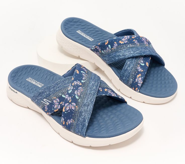 Your journey from the resort lobby to the sand or your neighbor's patio to the pool deck is comfier (and way cuter) in these flexible GoWalk slides with Goga Mat cushioning. From Skechers. Comfortable Beach Slippers With Removable Insole, Comfortable Slippers With Removable Insole For Beach, Non-slip Blue Slides For Vacation, Blue Non-slip Slides For Vacation, Comfortable Slides With Arch Support For Vacation, Lightweight Slip-on Slides For Vacation, Beach Slides With Arch Support, Adjustable Slippers With Arch Support For Vacation, Beach Season Slides With Cushioned Footbed