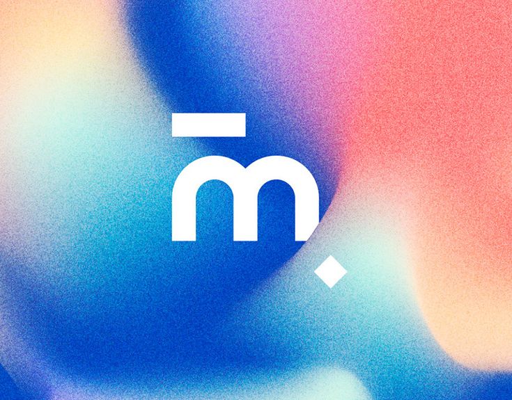 the letter m is placed on top of an abstract blurry background with blue and pink colors