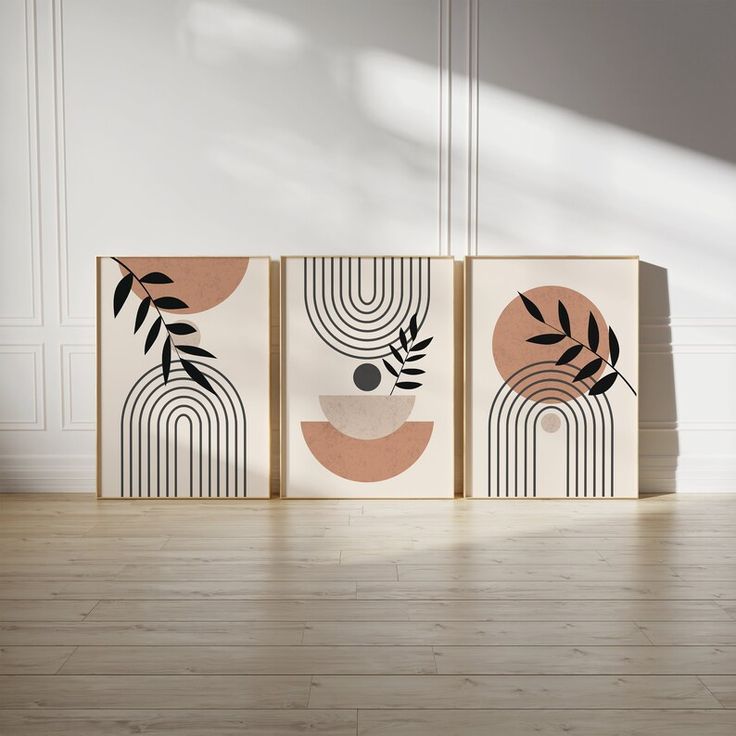 three abstract paintings are on display in an empty room with wood floors and white walls