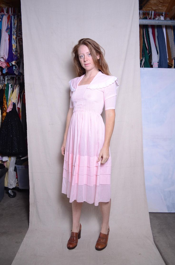 Vintage short sleeve smock dress semi sheer pullover  MATERIAL lightweight cotton  MAKER no label CONDITION great condition may show light wear from use SIZE extra small  check measurements as vintage sizes are different from today double measurements for the exact size no stretch to the material shoulders 14 in. pits 17 in. elastic waist 10 in. and 13 in. stretched fully  length 41 in. arm inseam 7.5 in. model is 5'6'' bust 33in. waist 27in hips 35in. wears a dress size 3/4 SHIPPING: standard p Feminine Fitted Vintage Summer Dress, Feminine Spring Vintage Dress With Square Neck, Feminine Square Neck Vintage Dress For Spring, Feminine Square-neck Vintage Dress For Spring, Feminine Square Neck Prairie Dress, Prairie Dress With Smocked Bodice And Short Sleeves, Pink Fitted Cottagecore Dress, Vintage Summer Dress With Lace Trim And Short Sleeves, Feminine Fitted Vintage Dress With Short Sleeves