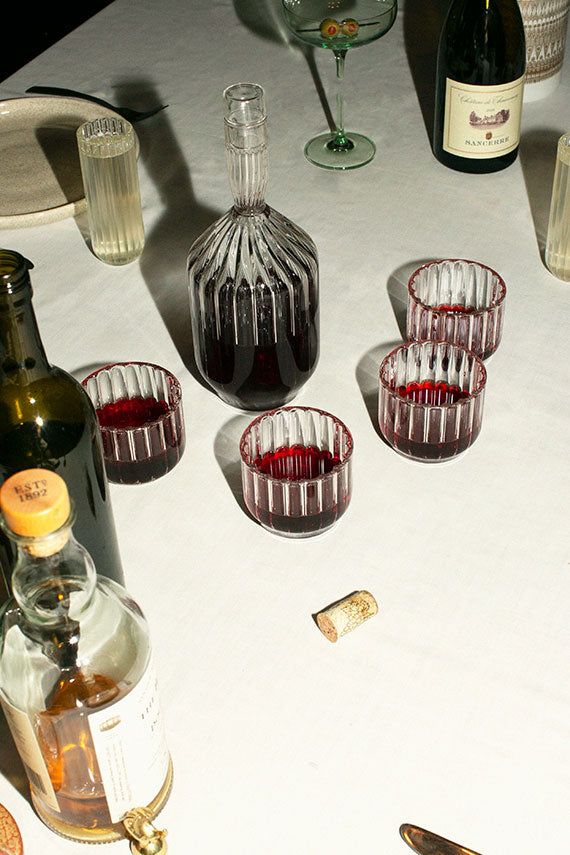 there are several glasses and bottles on the table