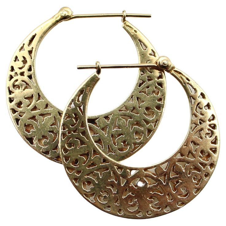 A very special pair of 14k gold vintage hoops that, when viewed from the side, are shaped like crescent moons. The earrings have a reticulated pattern that’s based on a fleur-de-lys motif. They consist of two layers of gold sandwiched on top of each other, which gives the illusion of depth, allowing you to see through to the pattern on the opposite side. The moon-shape and layered gold have the feel of exotic travels, making these a wonderful pair of vintage earrings perfect for any occasion. Fo Moon Shape, Moon Shapes, Pierced Ears, Vintage Earrings, Ear Piercings, Crescent, Jewelry Earrings, Hoop Earrings, Moon