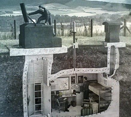 an old photo of a man sitting at his desk in the middle of a house