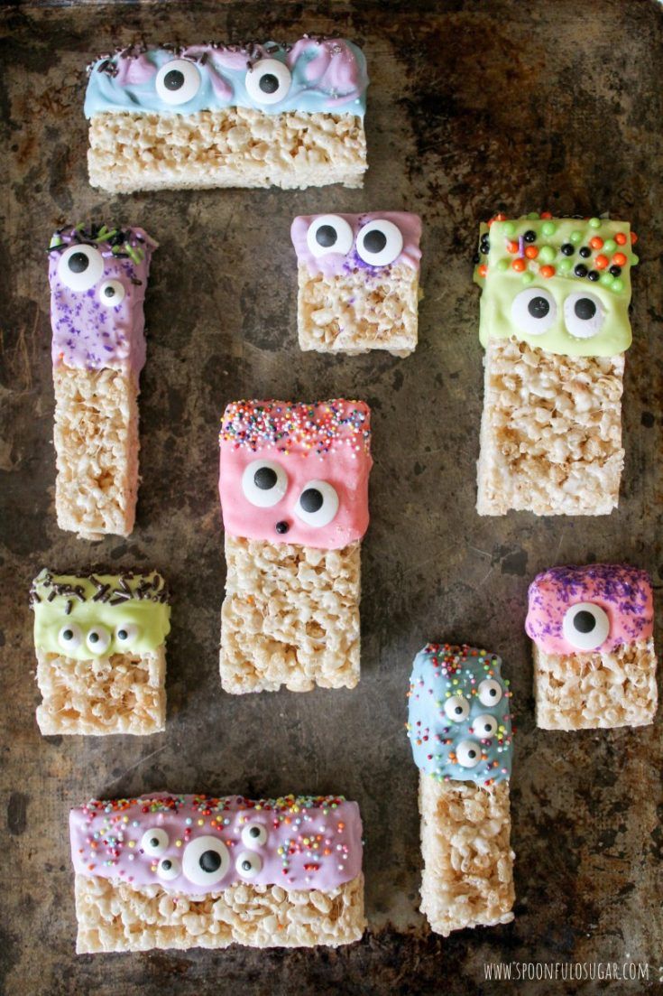 rice krispy treats with eyes and googly eyes are on a baking sheet, ready to be eaten