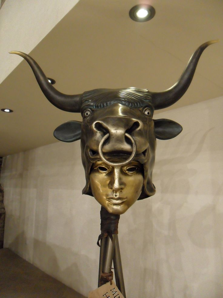 a statue of a bull's head wearing a mask